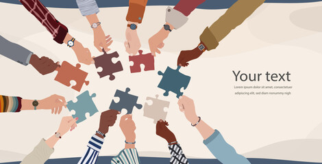 Group of multicultural business people with raised arms holding a piece of jigsaw. Colleagues of diverse ethnic groups and cultures. collaborate- Cooperate. Concept of teamwork.Copy space