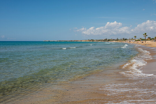 Beautiful beach with sand, turquoise and green water and dunes in Portopalo di Capopassero