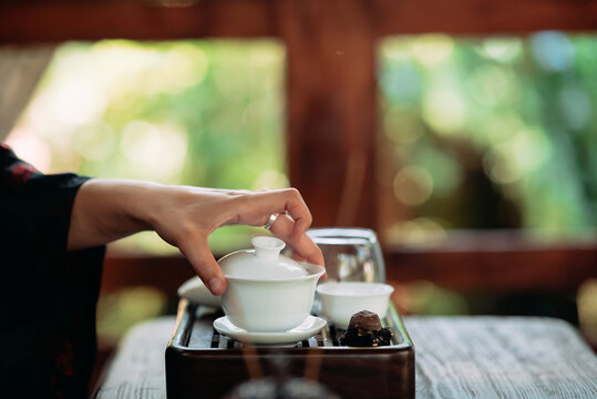 Process Brewing Tea. Woman Steeping Herbal Tea