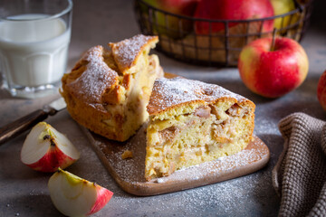 Layered apple pie on a wooden table, selective focus