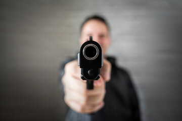 Brutal angry gang man lifestyle. Gangster action, killer aiming pistol gun. Guy shooting firearm...