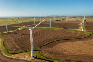 Wind farm photos, showing farm land and electricity generation - obrazy, fototapety, plakaty