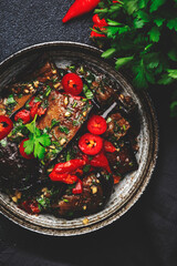 Grilled eggplant with hot red peppers, soy sauce and garlic in asian style, black background, top view - obrazy, fototapety, plakaty