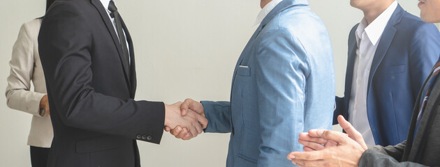 Two businessmen handshaking in meeting after final project agreement deal done.