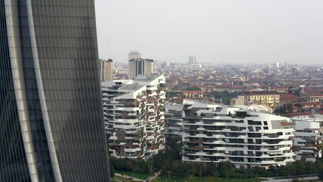 ITALY, MILAN 2022, drone aerial view of (Il DrittoThe Straight One), Generali (Lo StortoThe Twisted One), PwC (Il CurvoThe Curved On) in CityLife district  shopping - the new skyline of the city 