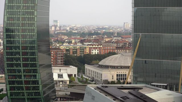ITALY, MILAN 2022, drone aerial view of (Il DrittoThe Straight One), Generali (Lo StortoThe Twisted One), PwC (Il CurvoThe Curved On) in CityLife district  shopping - the new skyline of the city 