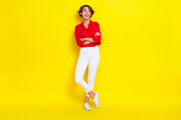 Fototapeta na wymiar Full body size photo of young person businesswoman wear formal outfit crossed arms looking empty space excited ad isolated on yellow color background