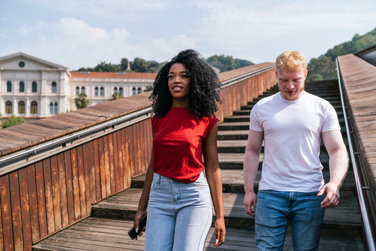 Serious diverse couple standing on stairs outside - Powered by Adobe