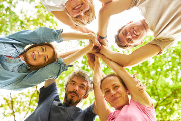 Young people giving the high five in a circle