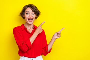 Photo of gorgeous impressed girl with bob hairstyle wear red shirt fingers directing empty space...
