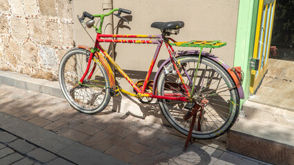 Colorful bicycle parked against the wall of the house