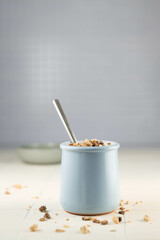 Healthy breakfast in a ceramic glass with yogurt, muesli and cookies. Healthy food. Side view. selective focus. Close-up.