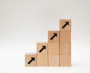 arrow sign on wood blocks step  up for business growth concept