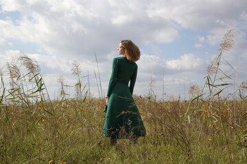 Serie of photos of female model in green dress posing on meadow. Outdoor portrait with natural light.	