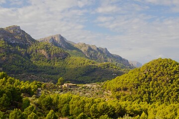 Aerial view of Serra de Tramuntana mountain range surrounded by buildings in Mallorca