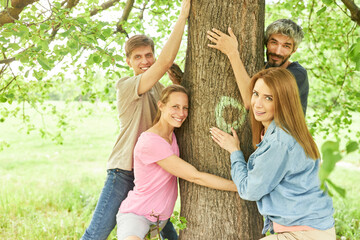 Group of friends feel relaxation while hugging tree