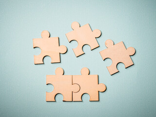Wooden puzzles jigsaw solving problems in business. Innovation and teamwork in the company with copy space.
