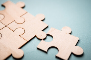 Wooden puzzles jigsaw solving problems in business. Innovation and teamwork in the company with...