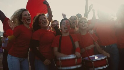 Crowd football fans cheering while watching soccer game at stadium - Sport entertainment concept - Powered by Adobe