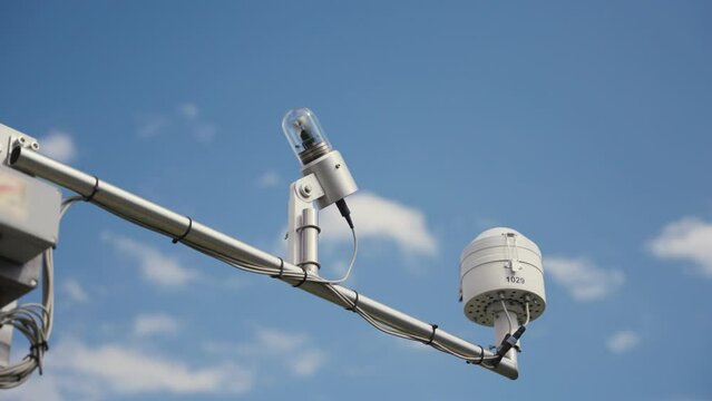 Radiometer and light meter instruments for weather conditions set up on antenna. Weather conditions with anemometer tool and devices set on towers and poles. Meteorological instruments under blue sky
