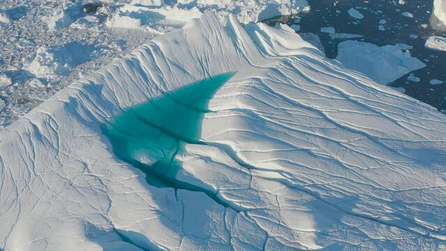 Icebergs drone aerial video top view - Climate Change and Global Warming - Icebergs from melting glacier in icefjord in Ilulissat, Greenland. Arctic nature ice landscape in Unesco World Heritage Site.