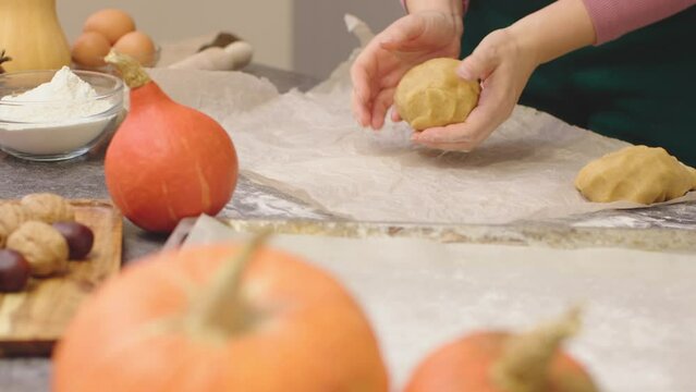 woman hands mashing ball pastry rolling raw dough cooking pumpkin pie or pumpkin sweets for happy thanksgiving holiday traditional dinner celebrating grateful holiday family dinner