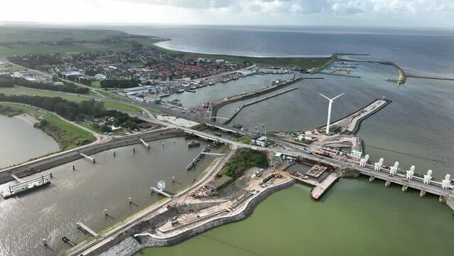 Afsluitdijk construction on pumping stations new sluices and the A7 near Den Oever, Kornwerderzand , and Zurich. Lock for shipping, road traffic cyclists and walkers. Aerial drone view.
