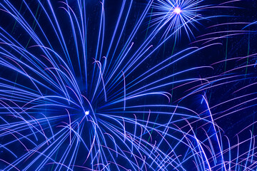 close up of blue fireworks in night sky