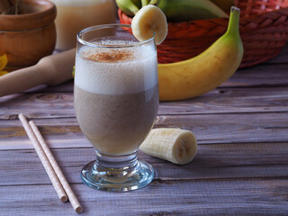 Banana smoothie on a white wooden table