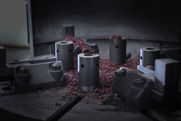 Naklejka na ściany i meble Metal shavings on the machine. Heavy industry. Production of bearings.Colored metal shavings .