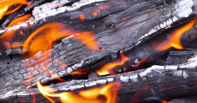 Burning logs and boards in the fire, kindling a fire for barbecue