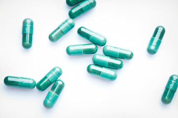 green medicine capsules isolated