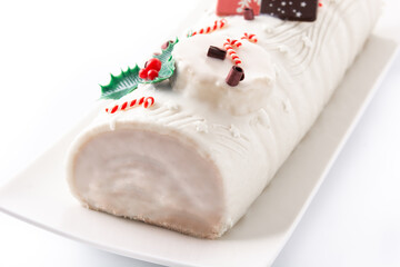 White chocolate yule log cake with christmas ornament isolated on white background