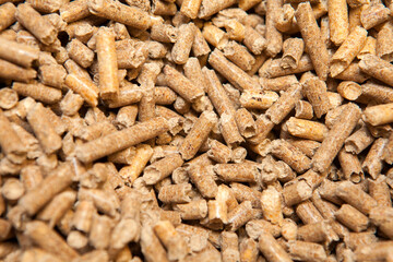 Wooden pellets background, pattern. Close up natural wood pellet. Ecological heating, renewable energy Biofuels. Top view. Flat lay ecological fuel for solid fuel boilers.