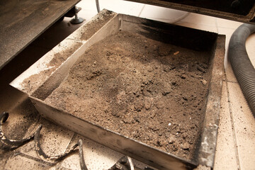 Used pellets in the form of ash, cleaning of an ecological pellet stove