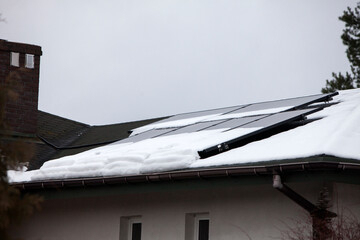 Solar panels on residential roof with snow