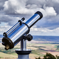 Telescope for tourists at a viewpoint to look at the landscape in the distance