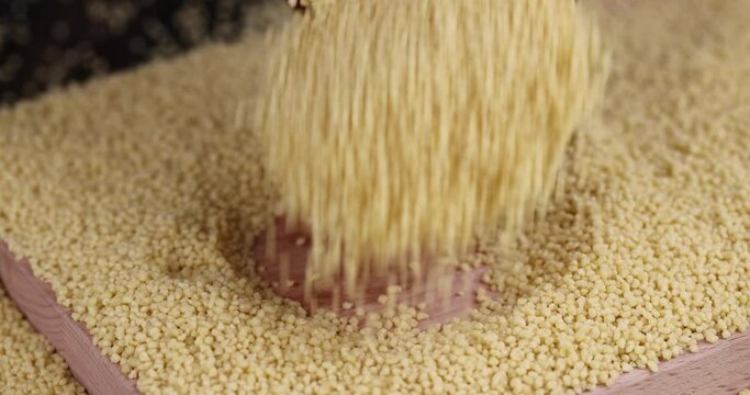 Sprinkle porridge couscous from wheat or millet, cooking dishes from traditional grits of crushed yellow couscous