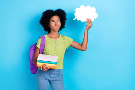 Portrait of thoughtful smart intelligent girl wavy hairdo green t-shirt hold book rucksack paper cloud isolated on blue color background - Powered by Adobe