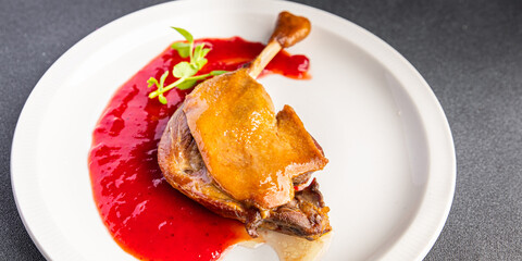 duck confit leg, red berry sauce  meal food snack on the table copy space food background 