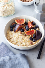 Oatmeal porridge with figs, blueberries, almonds and honey. Healthy eating. Vegetarian food. Breakfast.