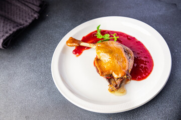 duck confit leg, red berry sauce  meal food snack on the table copy space food background 