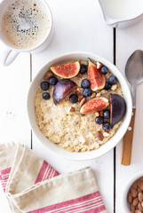 Oatmeal porridge with figs, blueberries, almonds and honey. Healthy eating. Vegetarian food. Breakfast.