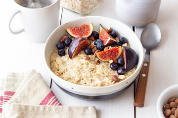 Oatmeal porridge with figs, blueberries, almonds and honey. Healthy eating. Vegetarian food. Breakfast.