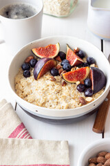 Oatmeal porridge with figs, blueberries, almonds and honey. Healthy eating. Vegetarian food. Breakfast.