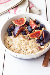 Oatmeal porridge with figs, blueberries, almonds and honey. Healthy eating. Vegetarian food. Breakfast.