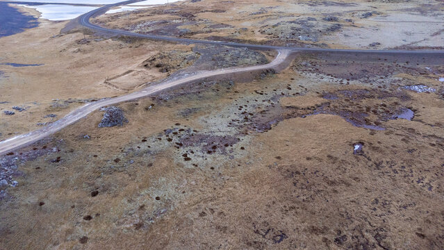 Drone view of asphalt road going through sandy valley in Iceland