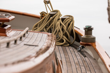 Bunch of mooring lines draped on the bow of a classic sailing vessel.