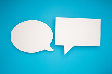 A blank white speech bubbles on a light blue background