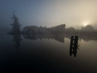 Windmill de Adriaan on a misty morning on the Spaarne River in Haarlem in the Netherlands